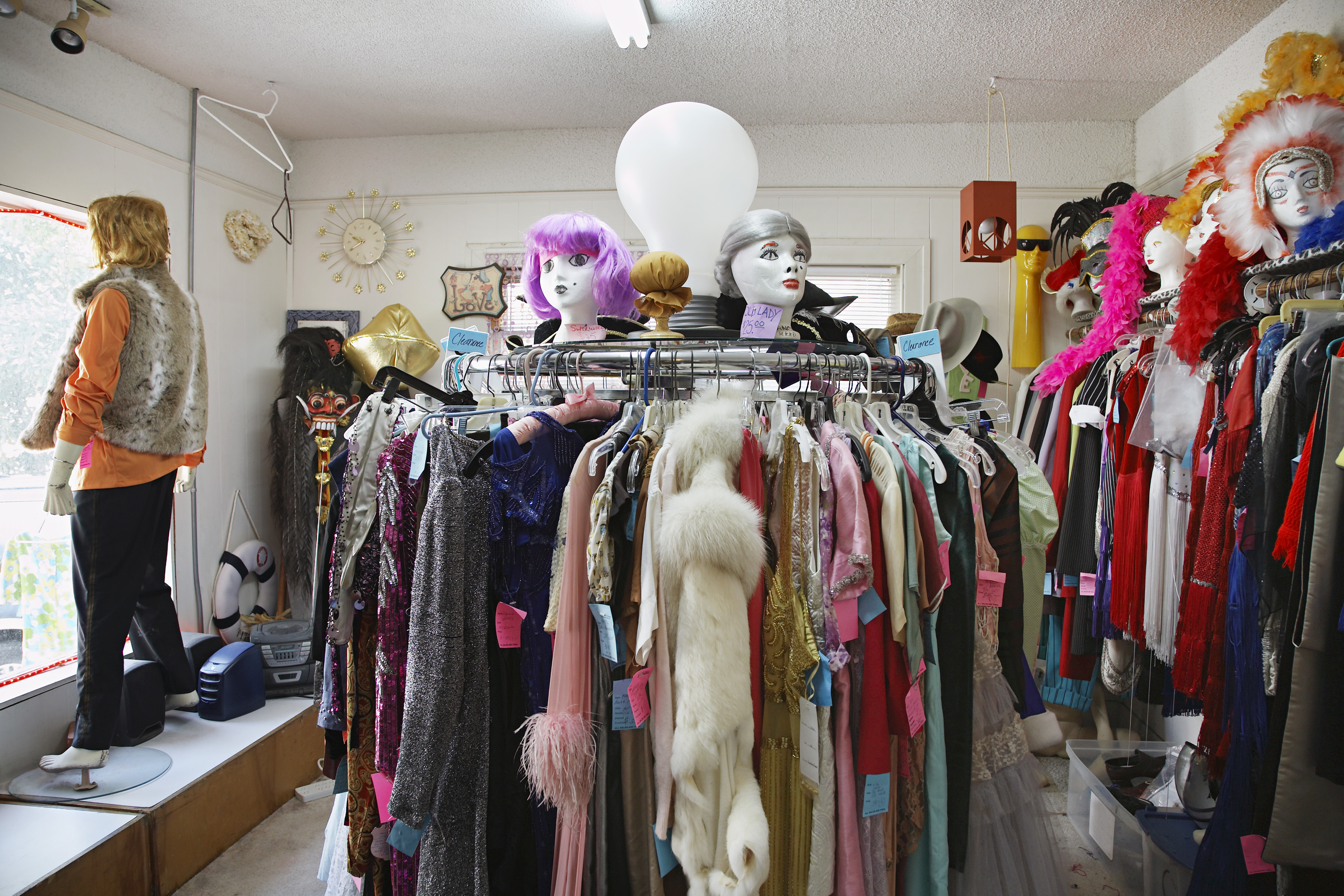 Clothing and wigs in crowded thrift store
